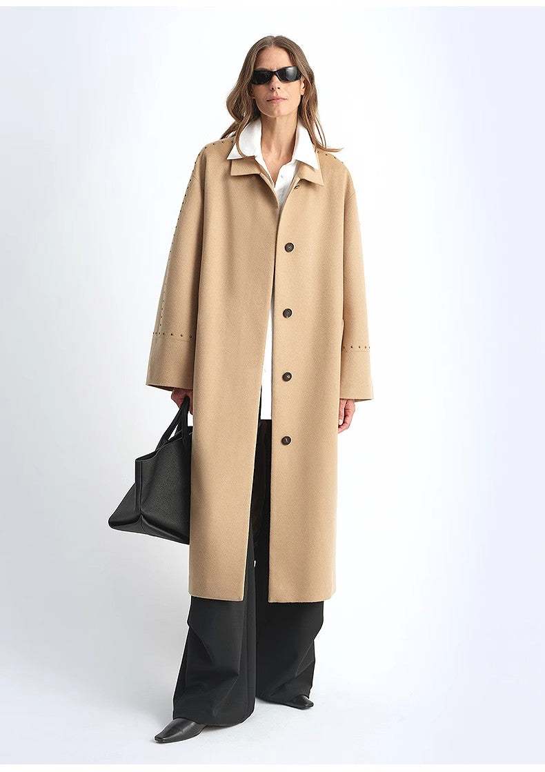 Woman wearing a beige trench coat on a white background